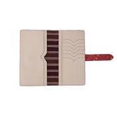 A red leather wallet with a floral pattern and a striped cotton lining visible from inside