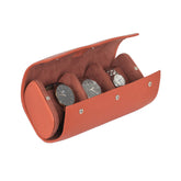 A tangerine leather watch roll box with microfibre interior, displaying watches through its open side.